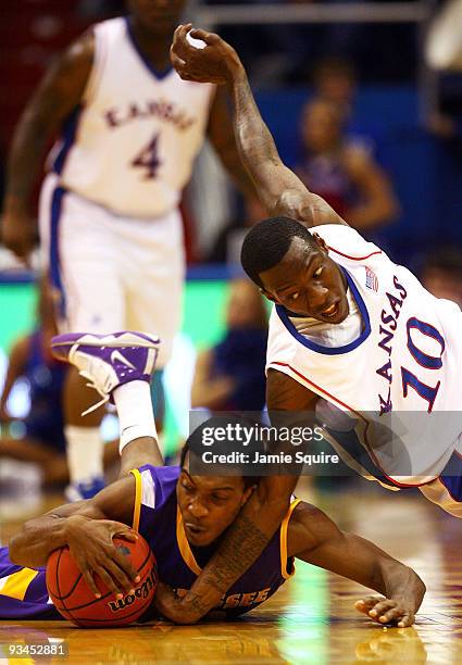 Elijah Muhammad of the Tennessee Tech Golden Eagles battles Tyshawn Taylor of the Kansas Jayhawks for a loose ball during the game on November 27,...