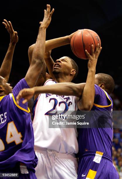 Marcus Morris of the Kansas Jayhawks shoots as Alfred Jones and Terrell Barnes of the Tennessee Tech Golden Eagles defend during the game on November...