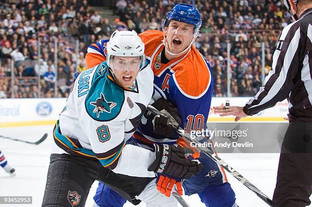 Joe Pavelski of the San Jose Sharks and Shawn Horcoff of the Edmonton Oilers fight for position at Rexall Place on November 27, 2009 in Edmonton,...