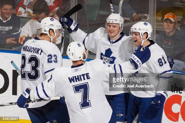Phil Kessel is congratulated by Alexei Ponikarovsky and Ian White of the Toronto Maple Leafs after scoring a goal against the Florida Panthers on...