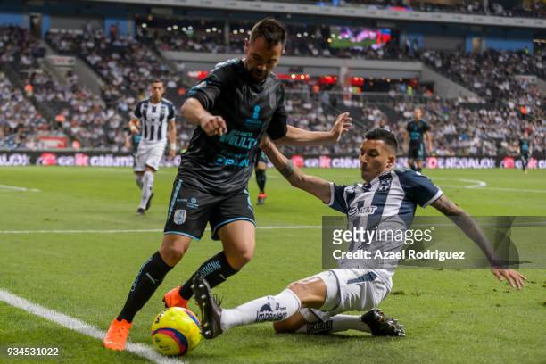 Leonel Vangioni of Monterrey fights for the ball with George Corral of Queretaro during the 12th round match between Monterrey and Queretaro as part...