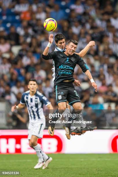 Stefan Medina of Monterrey heads the ball with Edgar Benitez of Queretaro during the 12th round match between Monterrey and Queretaro as part of the...