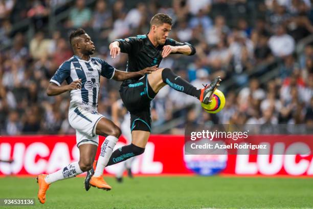 Aviles Hurtado of Monterrey fights for the ball with Hiram Mier of Queretaro during the 12th round match between Monterrey and Queretaro as part of...