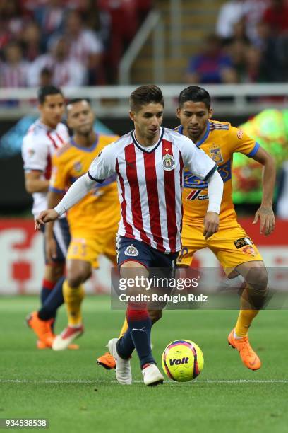Isaac Brizuela of Chivas fights for the ball with Javier Aquino of Tigres during the 12th round match between Chivas and Tigres UANL as part of the...