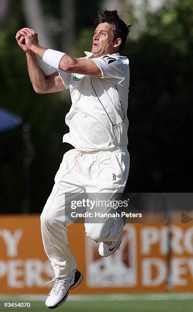 Shane Bond of New Zealand catches Umar Akmal out for 75 runs off his own bowling during day five of the First Test match between New Zealand and...