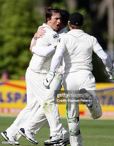 Shane Bond of New Zealand celebrates after catching Umar Akmal out for 75 runs off his own bowling during day five of the First Test match between...
