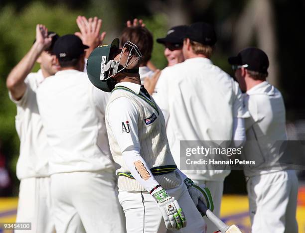 Umar Akmal walks off as New Zealand celebrate after being dismissed for 75 runs off Shane Bond's bowling during day five of the First Test match...