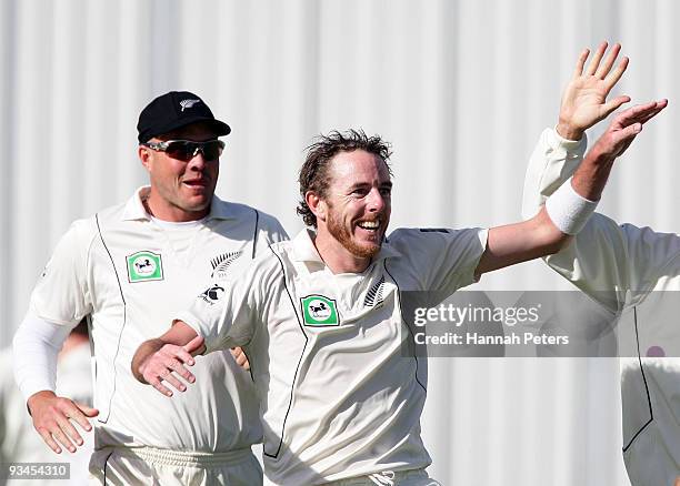 Iain O'Brien of New Zealand celebrates the wicket of Umar Gul of Pakistan caught for four runs by Daniel Vettori during day five of the First Test...