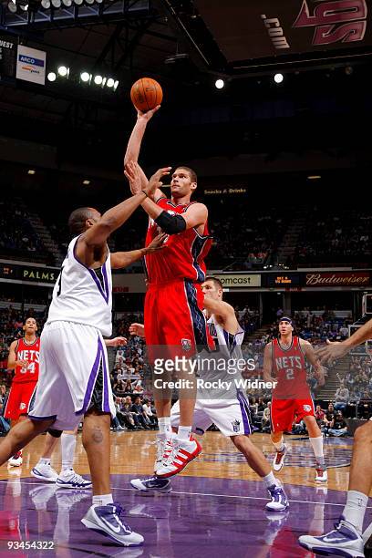 Brook Lopez of the New Jersey Nets shoots over Kenny Thomas of the Sacramento Kings on November 27, 2009 at ARCO Arena in Sacramento, California....