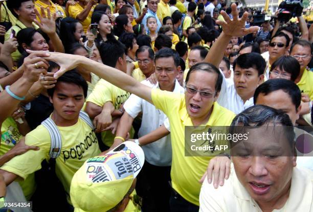 Liberal Party standard bearer Senator Benigno 'Noynoy Aquino, son of the late democracy icon Corazon Aquino, greets his supporters after a mass in...