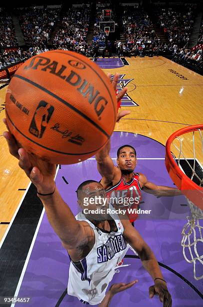 Kenny Thomas of the Sacramento Kings gets to the basket around Sean Williams of the New Jersey Nets on November 27, 2009 at ARCO Arena in Sacramento,...