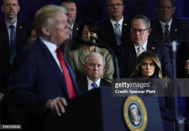 Attorney General Jeff Sessions and first lady Melania Trump watch as President Donald Trump, speaks to supporters, local politicians and police...