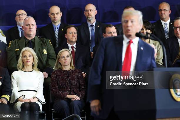 Advisor Kellyanne Conway watches as President Donald Trump speaks to supporters, local politicians and police officers at an event at Manchester...