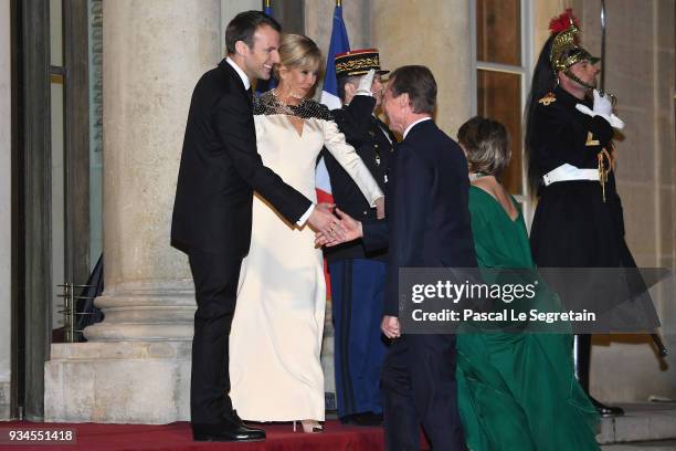 Grand-Duke Henri of Luxembourg and Grand-Duchess Maria Teresa of Luxembourg are greeted by French President Emmanuel Macron and Brigitte Macron as...