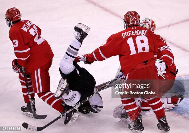 Providence Friars forward Erik Foley is flipped in the crease by a hit from Boston University Terriers forward Drew Melanson during the first period....