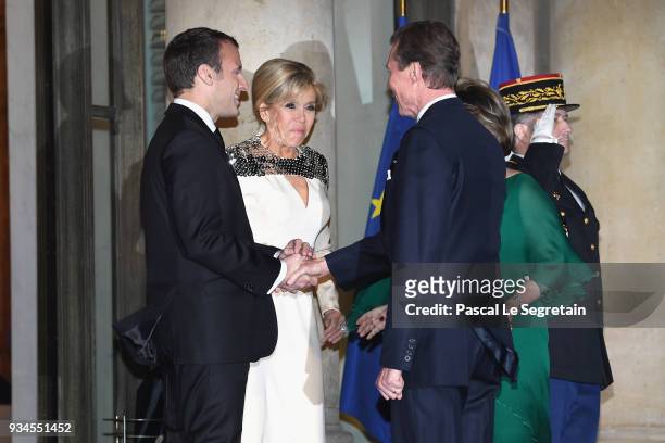 Grand-Duke Henri of Luxembourg and Grand-Duchess Maria Teresa of Luxembourg are greeted by French President Emmanuel Macron and Brigitte Macron as...