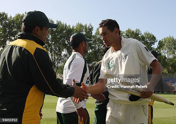 Ross Taylor of New Zealand shakes hands with Kamran Akmal of Pakistan after winning the First Test match on day five between New Zealand and Pakistan...