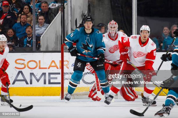 Jimmy Howard and Danny DeKeyser of the Detroit Red Wings defend the net against Tomas Hertl of the San Jose Sharks at SAP Center on March 12, 2018 in...