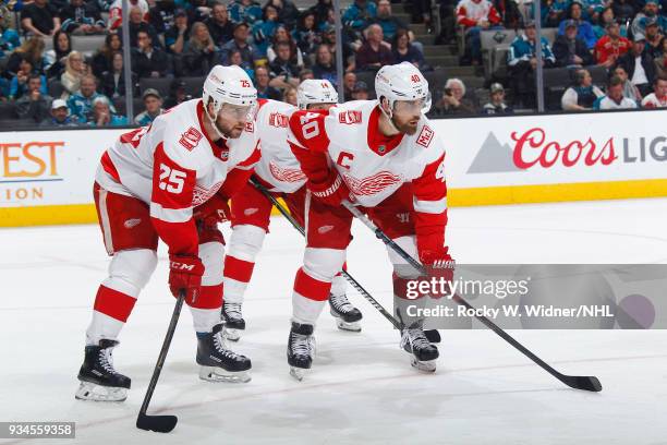 Mike Green, Gustav Nyquist and Henrik Zetterberg of the Detroit Red Wings face off against the San Jose Sharks at SAP Center on March 12, 2018 in San...