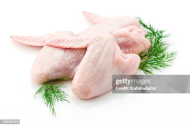 two raw chicken wings on white backdrop - raw chicken stockfoto's en -beelden