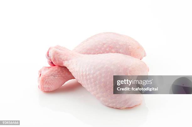 raw skin on chicken legs cross each other - chicken drumsticks stockfoto's en -beelden