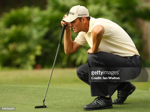 Martin Kaymer of Germany lines a put during the Fourballs on the 3rd day of the Omega Mission Hills World Cup on the Olazabal course on November 28,...