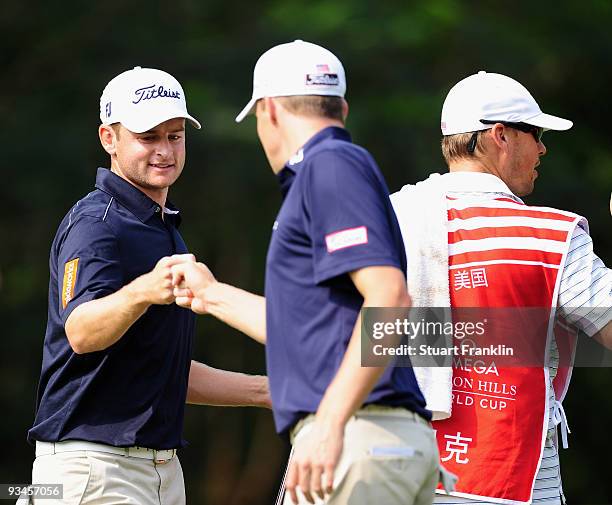 John Merrick and Nick Watney of USA celebrate on the 13th hole during Fourball on the third day of the Omega Mission Hills World Cup on the Olazabal...