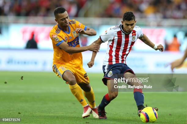Orbelin Pineda of Chivas fights for the ball with Rafael de Souza of Tigres during the 12th round match between Chivas and Tigres UANL as part of the...