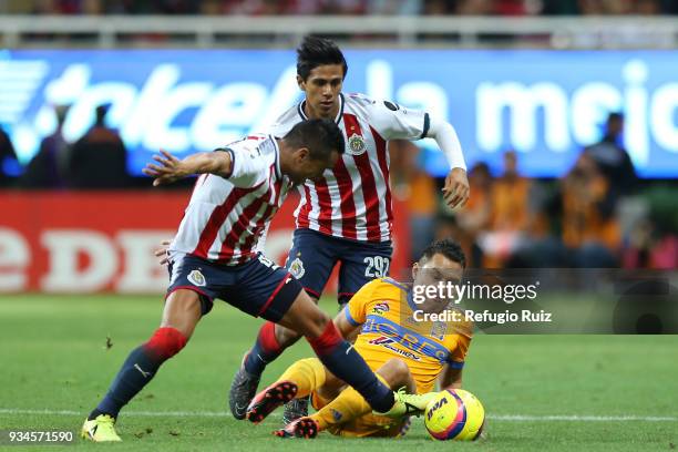 Edwin Hernandez of Chivas fights for the ball with Juninho of Tigres during the 12th round match between Chivas and Tigres UANL as part of the Torneo...