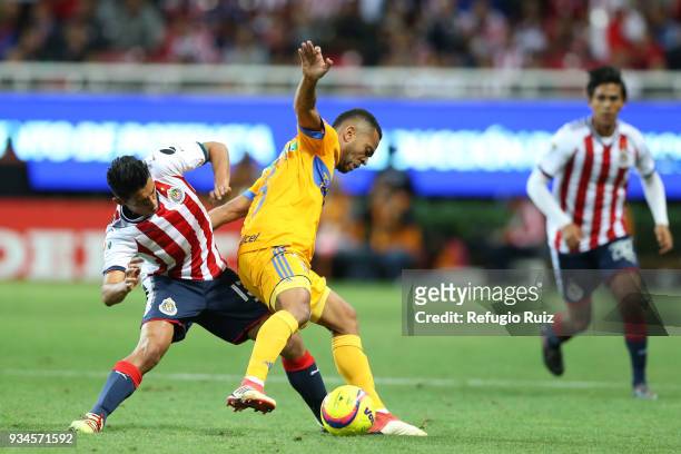 Walter Sandoval of Chivas fights for the ball with Rafael de Souza of Tigres during the 12th round match between Chivas and Tigres UANL as part of...