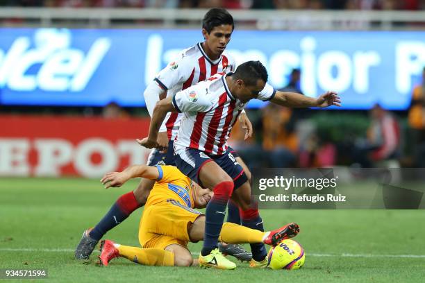 Edwin Hernandez of Chivas fights for the ball with Juninho of Tigres during the 12th round match between Chivas and Tigres UANL as part of the Torneo...