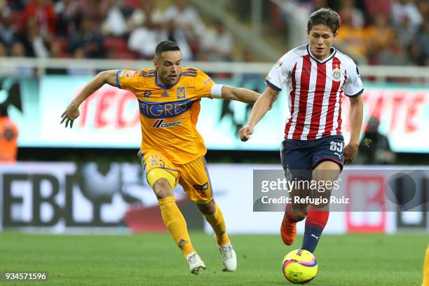 Jesus Godinez of Chivas fights for the ball with Juninho of Tigres during the 12th round match between Chivas and Tigres UANL as part of the Torneo...