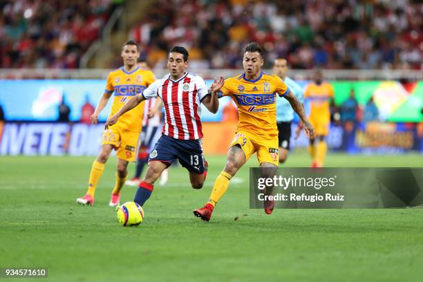 Walter Sandoval of Chivas fights for the ball with Eduardo Vargas of Tigres during the 12th round match between Chivas and Tigres UANL as part of the...