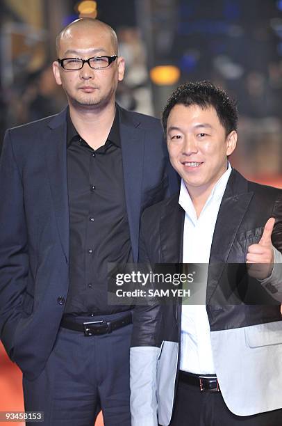 Chinese actor Huang Bo and director Guan Hu arrive ahead of the Golden Horse Awards, considered the Chinese-language "Oscars", in Taipei on November...