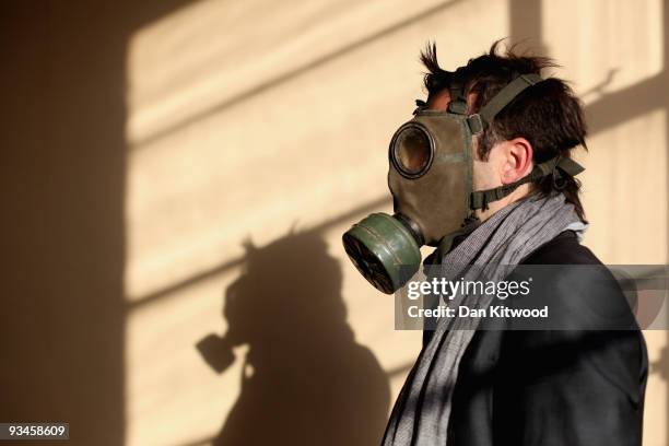 Man tries on a gas mask at Angels Costumiers Uniform Sale, in a warehouse in Wembley on November 28, 2009 in London, England. The Angels Uniform Sale...