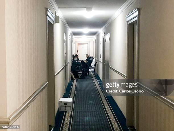 Toronto police officers are seen sitting in the hallway outside of Bruce McArthur's apartment located at 95 Thorncliffe Park Dr. In Toronto.