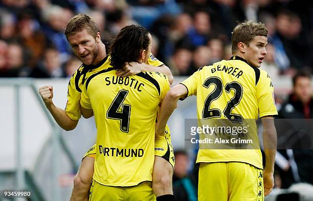 Jakub Blaszczykowski of Dortmund celebrates scoring his team's first goal with team mates Neven Subotic and Sven Bender during the Bundesliga match...