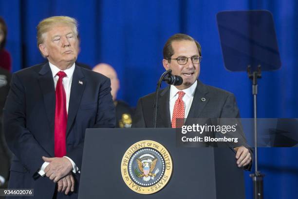 Alex Azar, secretary of Health and Human Services , right, speaks while U.S. President Donald Trump listens during an event at Manchester Community...