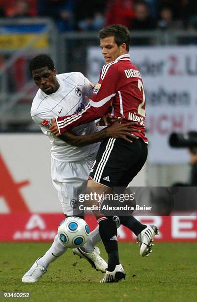 Dennis Diekmeier of Nuernberg fights for the ball with Mohamadou Idrissou of Freiburg during the Bundesliga match between 1. FC Nuernberg and SC...