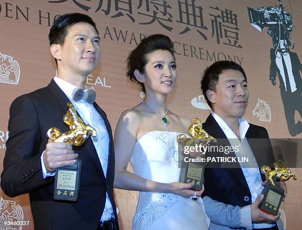 Hong Kong actor Nick Cheung, , Chinese actress Li Bingbing and actor Huang Bo hold trophies after winning the Best Leading Actors and Actress awards...