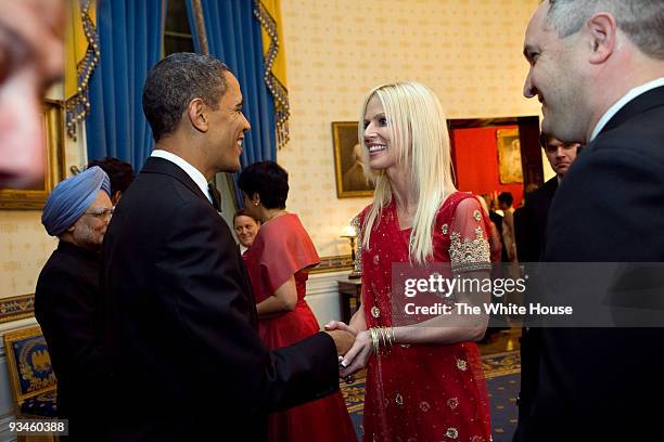 In this handout provided by the White House, U.S. President Barack Obama shakes hands with Michaele and Tareq Salahi of Virginia at the receiving...