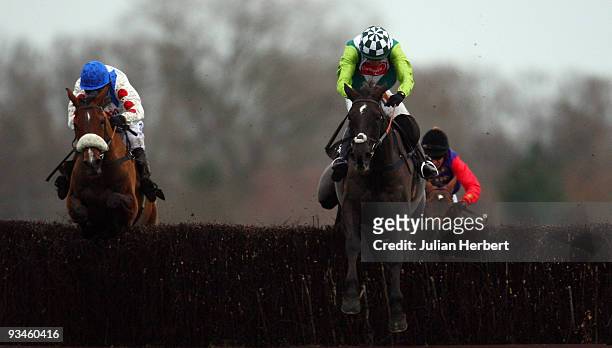 Ruby Walsh and Denman clear the last fence in company with the Sam Thomas ridden What A Friend before going on to win The Hennessy Cognac Gold Cup...