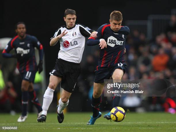 Ivan Klasnic of Bolton contests with Chris Baird of Fulham during the Barclays Premier League match between Fulham and Bolton Wanderers at Craven...