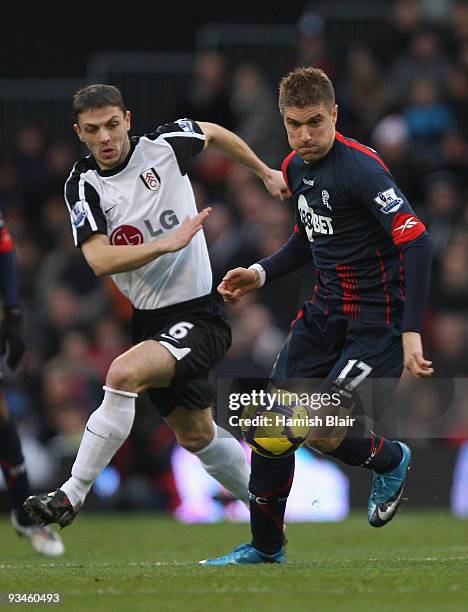 Ivan Klasnic of Bolton contests with Chris Baird of Fulham during the Barclays Premier League match between Fulham and Bolton Wanderers at Craven...