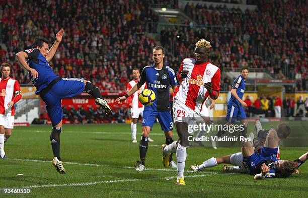 Piotr Trochowski of Hamburg kicks away the ball in front of Aristide Bance of Mainz during the Bundesliga match between FSV Mainz 05 and Hamburger SV...