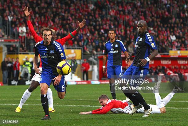 Andre Schuerrle of Mainz falls in the penalty area as Hamburg defenders follow the ball during the Bundesliga match between FSV Mainz 05 and...