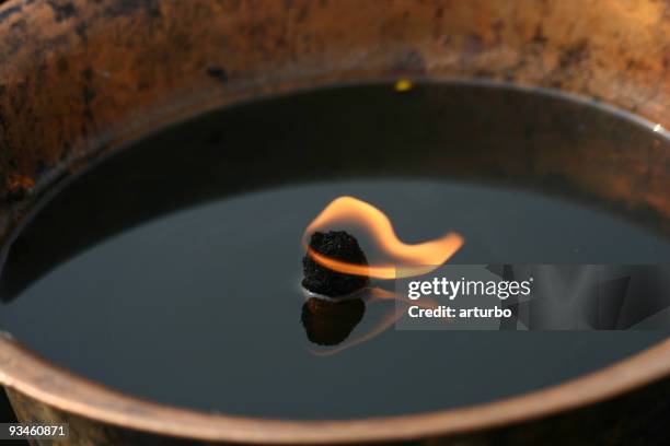 one oil lamp in a tibetan buddhist temple - black temple stock pictures, royalty-free photos & images
