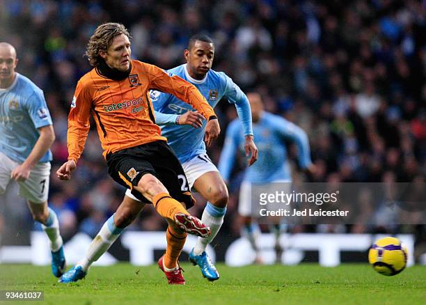 Jimmy Bullard of Hull City controls the ball ahead of Robinho of Manchester City during the Barclays Premier League match between Manchester City and...