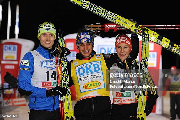 Hannu Manninen of Finland, Jason Lamy-Chappuis of France and Eric Frenzel of Germany pose after the Ski Jumping/10km Gundersen event during day one...