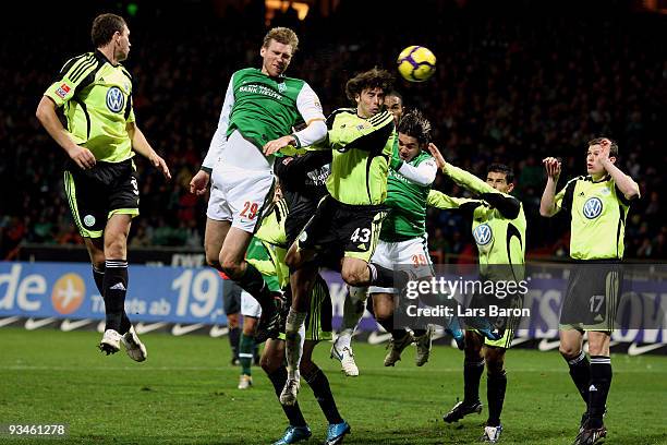 Per Mertesacker of Bremen heads his team's second goal during the Bundesliga match between SV Werder Bremen and VfL Wolfsburg at Weser Stadium on...